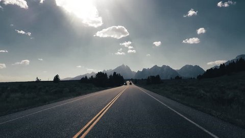 Driving a Car towards Grand Teton, back light, Point of View - Mounted 2.7k Ultra HD footage