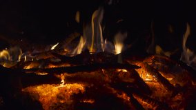 Fire on bonfire red-hot coals close up. 4K UHD video footage