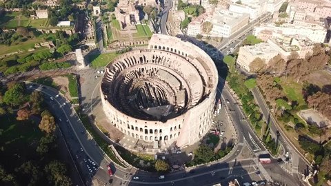 Aerial drone view video of iconic ancient Arena of Colosseum, also known as the Flavian amphitheatre in the heart of Rome, Italy