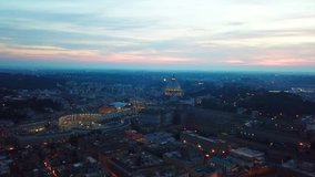Aerial drone night video of iconic Saint Peter Basilica and Cappella Sistina Cathedral in famous city of Vatican at dusk with beautiful colors, Borgo district, Rome, Italy
