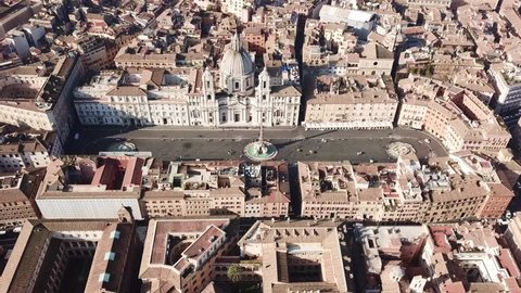 Aerial drone view of iconic landmark Piazza Navona (Square) featuring Fountain of the Four Rivers with an Egyptian obelisk and Sant Agnese Church in the heart of Rome, Italy