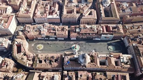 Aerial drone top view of iconic landmark Piazza Navona (Square) featuring Fountain of the Four Rivers with an Egyptian obelisk and Saint Agnese Church in the heart of Rome, Italy