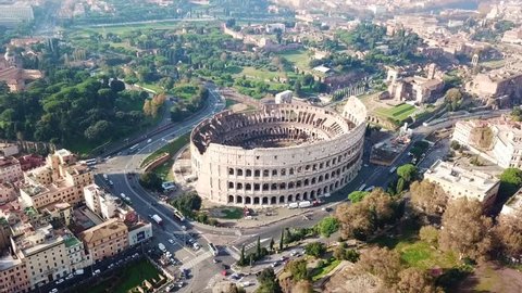 Aerial drone view video of iconic ancient Arena of Colosseum, also known as the Flavian amphitheatre in the heart of Rome next to Roman Forum, Italy