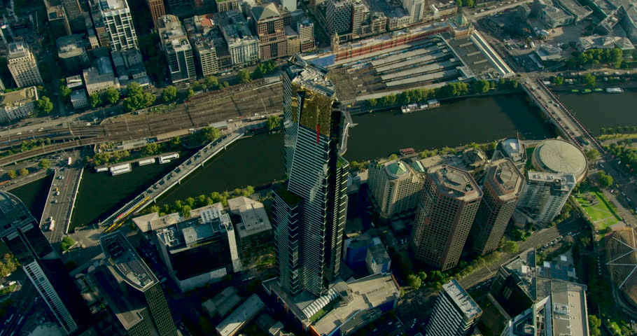 Aerial sunrise view around Eureka Tower alongside Yarra River Flinders Street Station and Federation Square Melbourne Victoria Australia