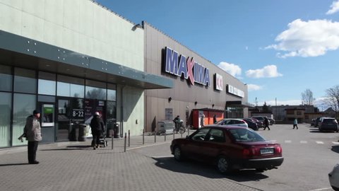 KURESSAARE, ESTONIA - CIRCA MAR, 2018: Main entrance of building of supermarket Maxima XX with visitors. It is one of the largest shops is on Saaremaa island