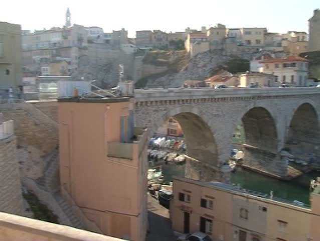 the view on the small fishing boats in haven through the old arch bridge, Vallon des Auffes, Marseille