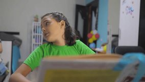 little girl daughter do homework education lesson school. slow motion lifestyle video. preparation, back to school. little girl study with a book. school kids family concept education