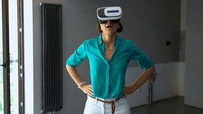 Woman with vr goggle watching virtual project at new home