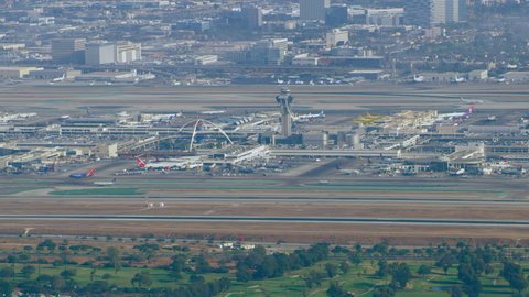 Los Angeles, California CIRCA - 2018. Aerial view of airplane landing at LAX runway on a sunny day in Los Angeles, California. Shot on 4K RED camera. 