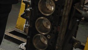 Cylinder head. Cylinder head removed from engine for repair. Parts in the engine oil. Disassembled motor vehicle for repair. Parts in engine oil. Car engine repair in the service.
