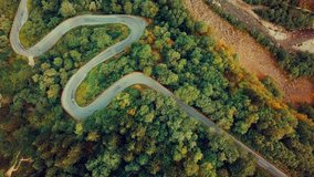 Aerial View landscape serpentine road winding on the mountains background in summer sunny day, Drone 4K Video
