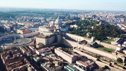 Aerial drone video of Saint Peter's square in front of world's largest church - Papal Basilica of St. Peter's, Vatican - an elliptical esplanade created in the mid seventeenth century, Rome, Italy