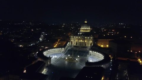 Aerial drone night view of Saint Peter's square in front of world's largest church -Basilica of St. Peter's, Vatican -an elliptical esplanade created in the mid seventeenth century, Rome, Italy