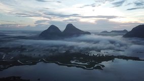 Aerial view beautiful scenery  of Timah Tasoh Lake during sunrise, with dramatic rolling cloud formation. 