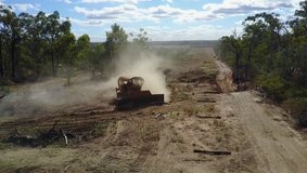 View from the air of bulldozer pushing dirt and trees, Queensland, Australia