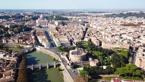 Aerial drone view video of iconic Castel Sant' Angelo (castle of Holy Angel) and Ponte or bridge Sant'Angelo with statues in river of Tiber next to famous Vatican, Rome, Italy