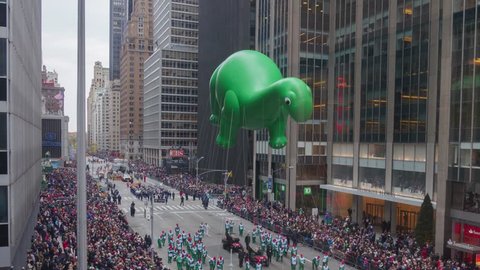 NEW YORK CITY - NOVEMBER 2016: Timelapse of Macy's Thanksgiving Day Parade Balloons marching on 6th Avenue with Dino balloon and Angry Birds Red balloon in New York City, USA. View from above.