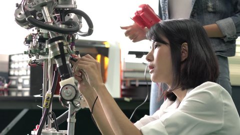 Engineer female collaborating development robot in modern laboratory. concept of hardware technology, robotic engineering, artificial intelligence and automation control. 4K Resolution.