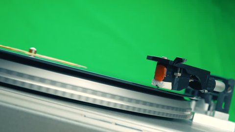 Rotating vinyl player with a plate on a background of green chroma key color. 4k UltraHD footage.
