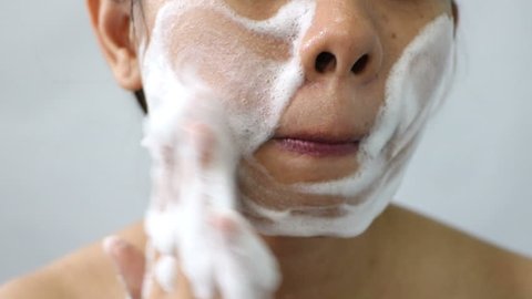 Close up Asian woman washing face by make bubble facial foam and cleansing her face skin