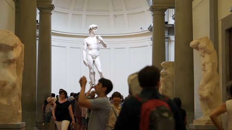 Firenze, Italy - August 30, 2018: Many people in famous Florence Accademia art museum gallery looking at view of David statue of Michelangelo