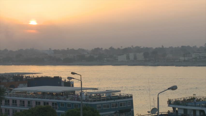 the Nile river reflecting a golden sky /Luxor, Egypt