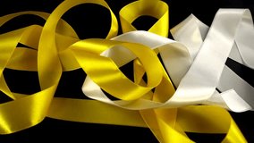 Satin ribbons on a black background. 
Slow motion. - Powered by Shutterstock - Get 15% off with code: PIKWIZARD15