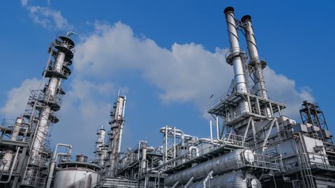 Time lapse of industrial plant with furnace and heat exchanger cracking hydrocarbons in factory on blue sky background, Close up of equipment in petrochemical plant