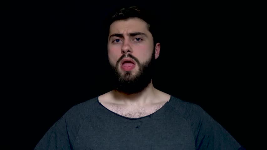 Impressed young bearded man applauding on black background. Young handsome guy with beard clapping his hands