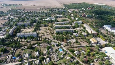 Gorgeous bird`s eye shot of Askania-Nova village, the heart of Oleshky steppe biosphere reserve with big and small houses and parks in summer 