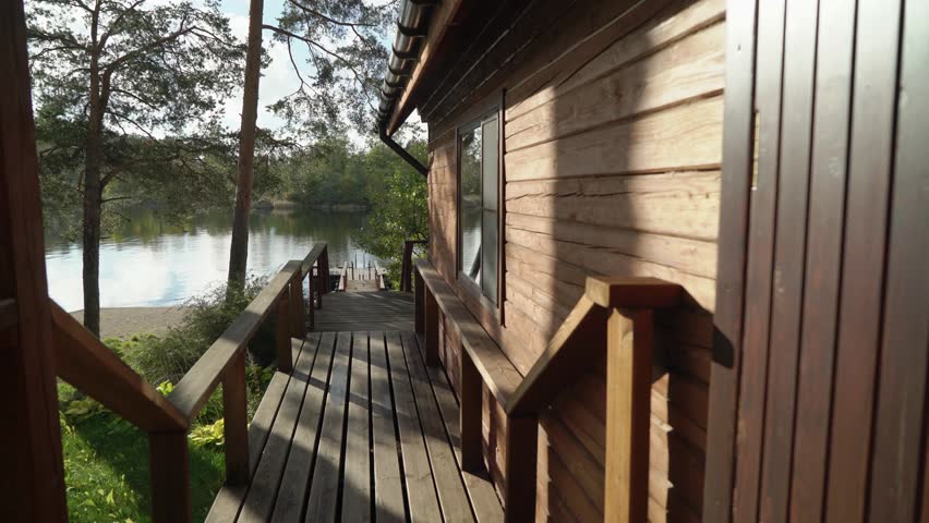 A wooden cottage near lake or sea. Luxury house for vacations. Summer day