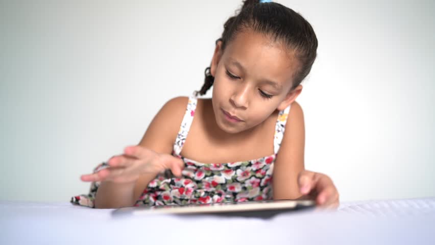 Cute Little Girl Using Tablet at Home
