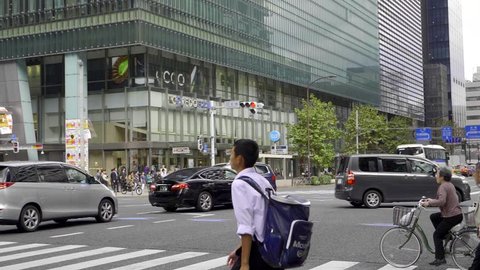 Tokyo, Japan - September 25, 2018: Japan office workers crossing the road in Yaesu area in Tokyo.