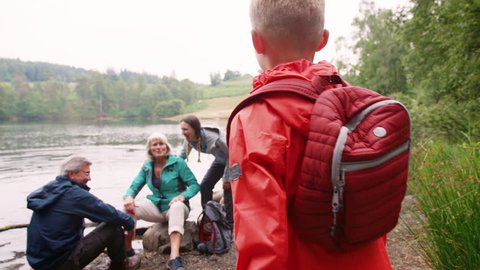 Multi generation family spending time together by a lake in the countryside, close up, Lake District, UK