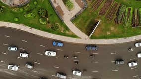 Rotating traffic shot Top view lahore with green parks and trees with cars driving around. Shot from Drone Full HD vivid video