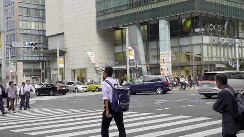 Tokyo, Japan - September 25, 2018: Japan office workers crossing the road in Yaesu area in Tokyo.