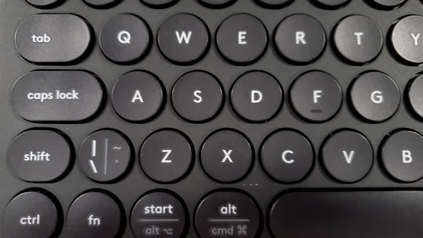 Black keyboard keys, close up panning from left to right.