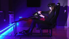 Young woman playing in car drive simulator at VR club, using modern virtual reality headset. Future and video game concept, overall plan