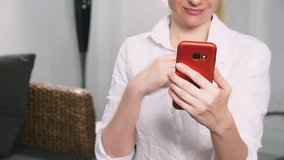woman flirts talking on video communication from her smartphone. A woman sends a kiss online during a video call using a smartphone.