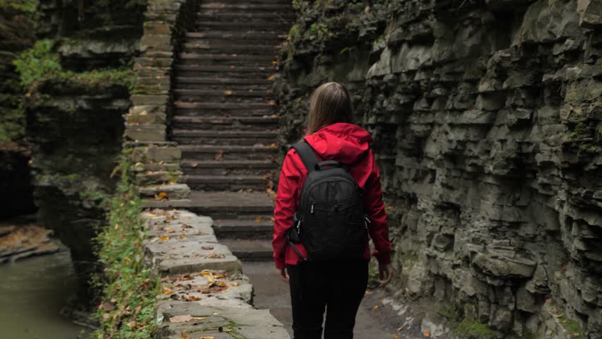 Female tourist walking through Watkins Glen State Park natural gorge 02
