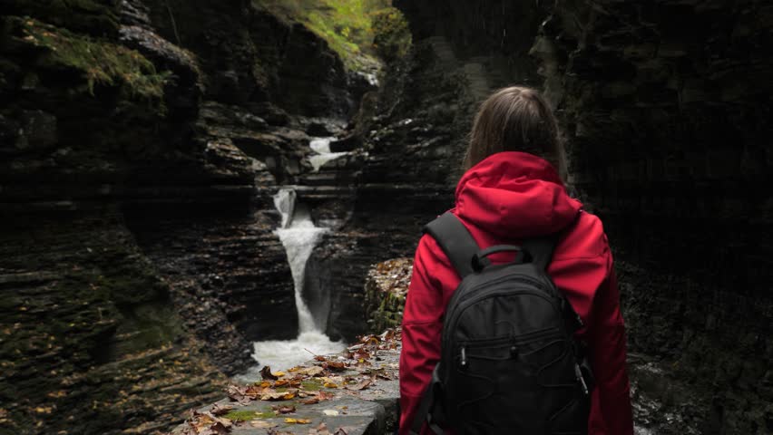 Female tourist walking through Watkins Glen State Park natural gorge 08