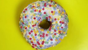 donut with different fillings and icing on yellow background. Rotation video