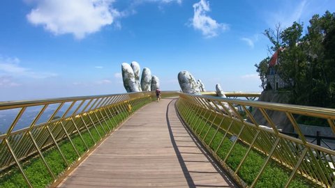 Da Nang, Vietnam - October 31, 2018: Tourists in Golden Bridge known as “Hands of God”, a pedestrian footpath lifted by two giant hands, open in July 2018 at Ba Na Hills in Da Nang, Vietnam.