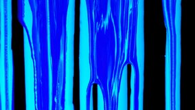 Ideally for video and motion graphics integration for intro or outro. Ultraviolet luminescence blue ink. Colorful splashes of liquid ink flow down slows. Isolated on black background