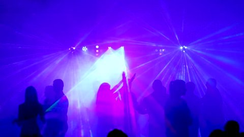 Nightclub. Ibiza June 2018. Young people dance and have fun at a party with bright illumination and a light laser show.
