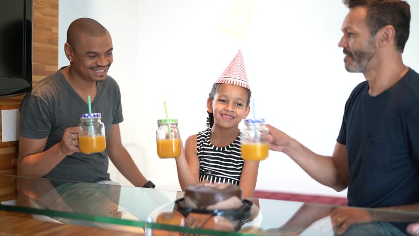 Modern Family - Gay Couple with Adopted Children - on celebratory toast