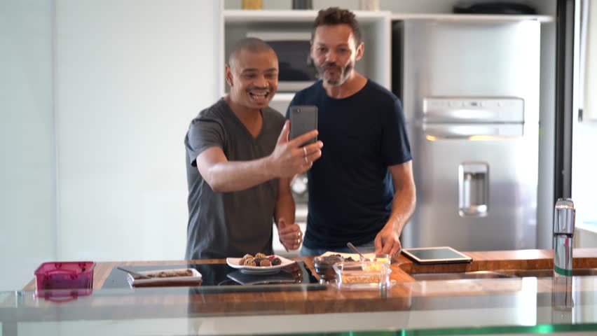 Gay Couple Making a Video Chat After Cooking Chocolate / Brigadeiro at Kitchen | Shutterstock HD Video #1019902582