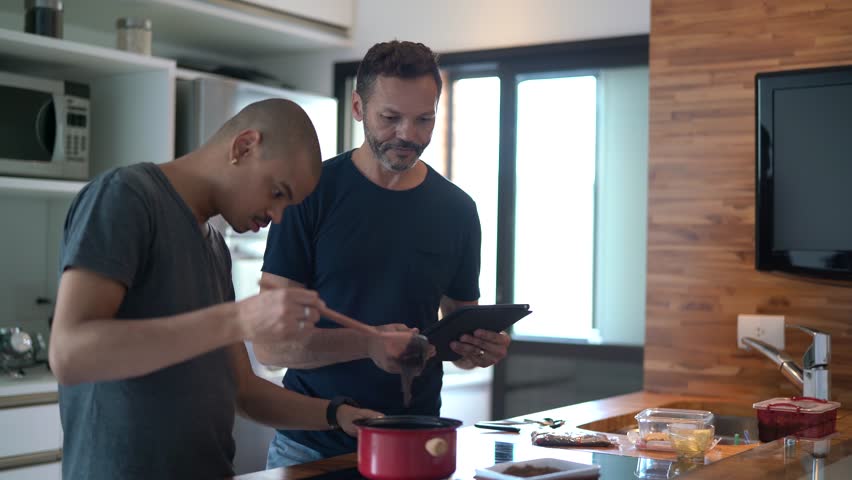 Gay Couple Making Chocolate - Brigadeiro at Kitchen