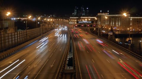 Timelapse.Night city traffic on the highway. Speed Limit Signs
