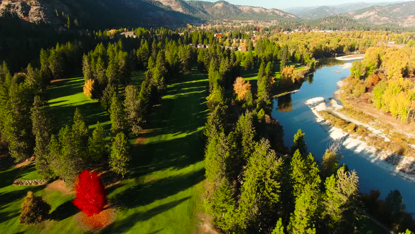 Pristine Fall Colors Over Golf course with River and Small Mountain Community 